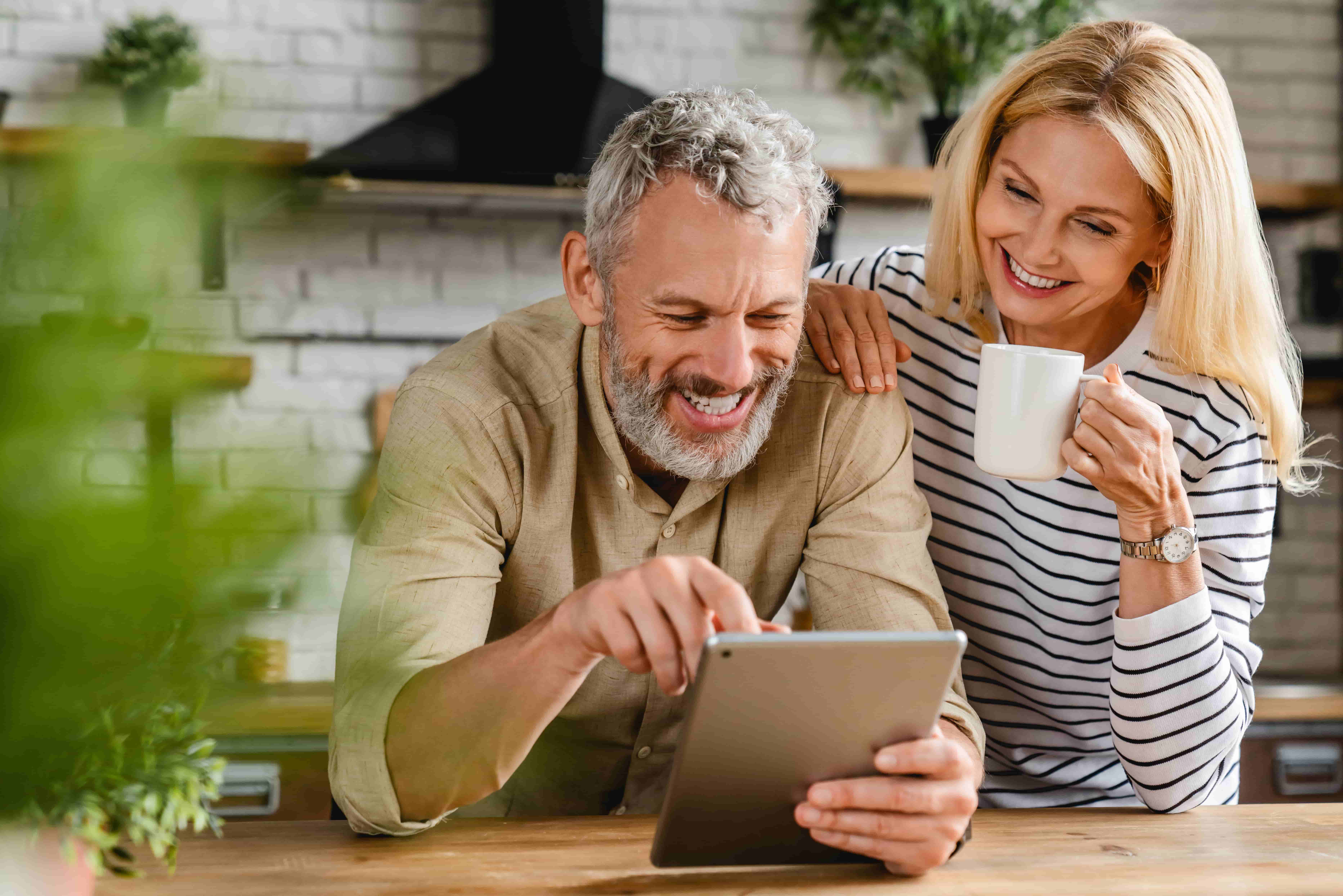 Happy senior couple using digital tablet